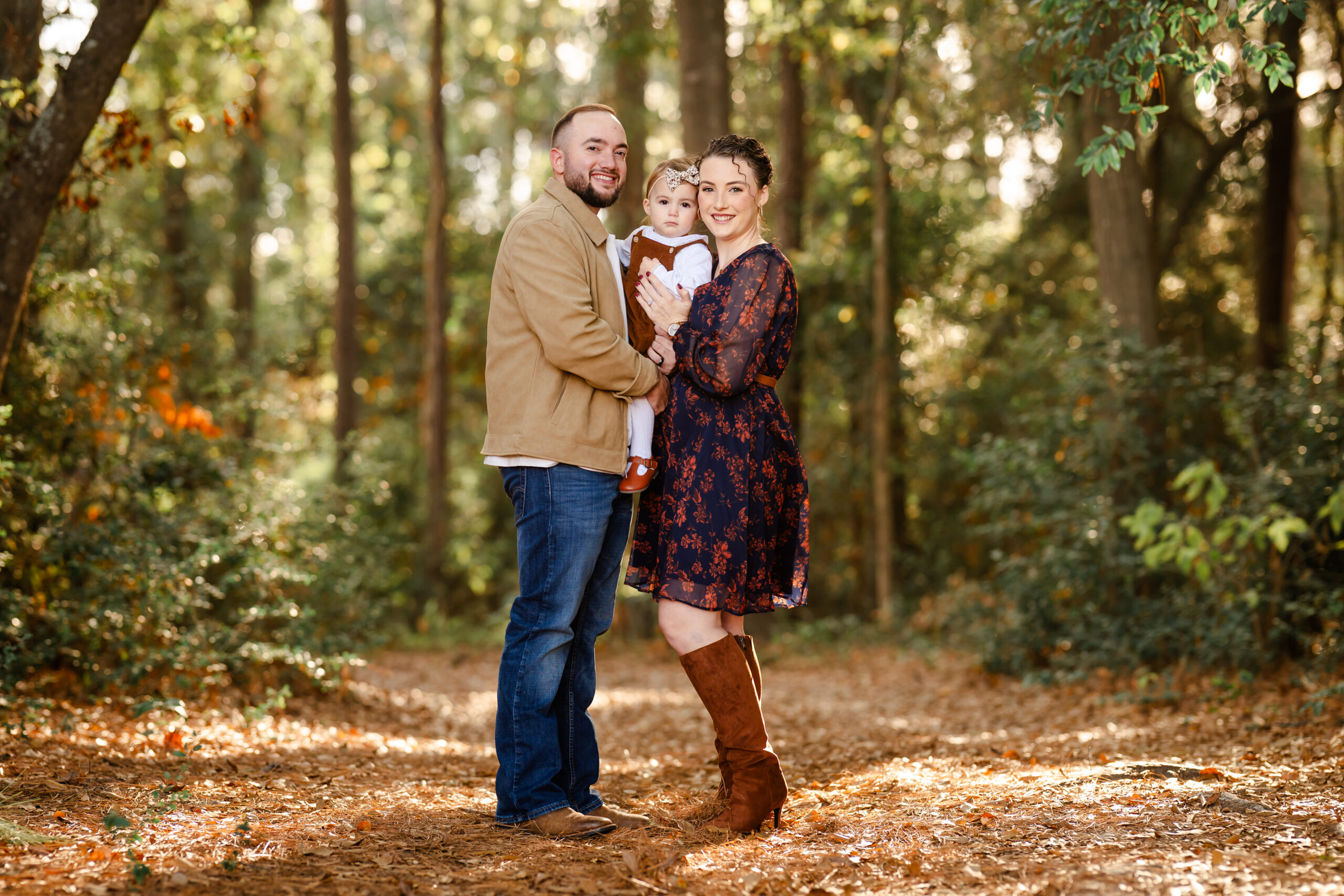 Picture of a family of three in a forest setting near Willis, Texas.
