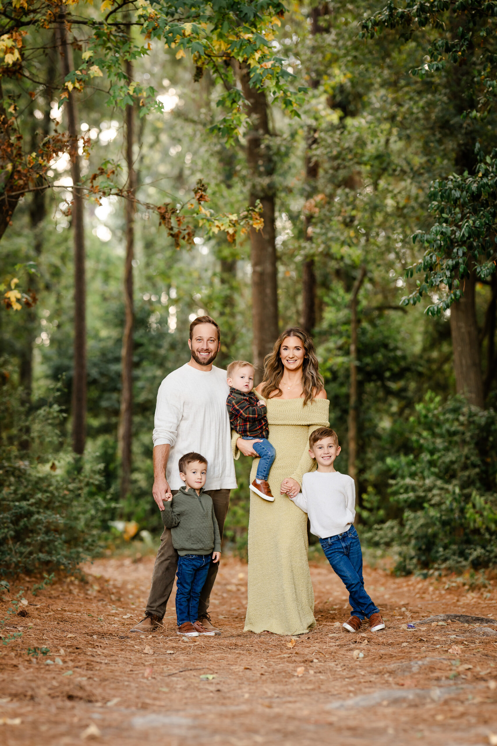 Picture of a family of five posing in a forest setting near The Woodlands, Texas.