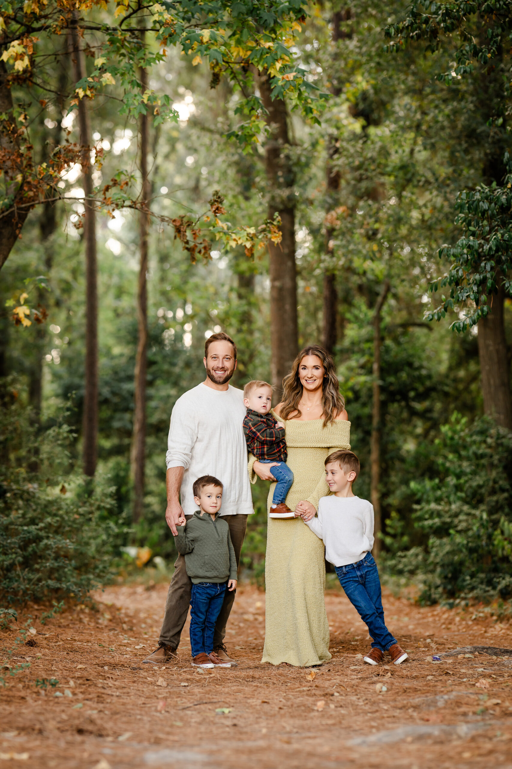 Picture of a family of five standing in a forest setting near Montgomery, Texas.